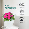Go Hooked white plastic planter pot with embossed pattern, holding pink flowers. Indoor/outdoor use.