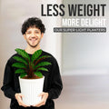 Go Hooked white ribbed plastic planter pot with a green plant, held by a smiling man.