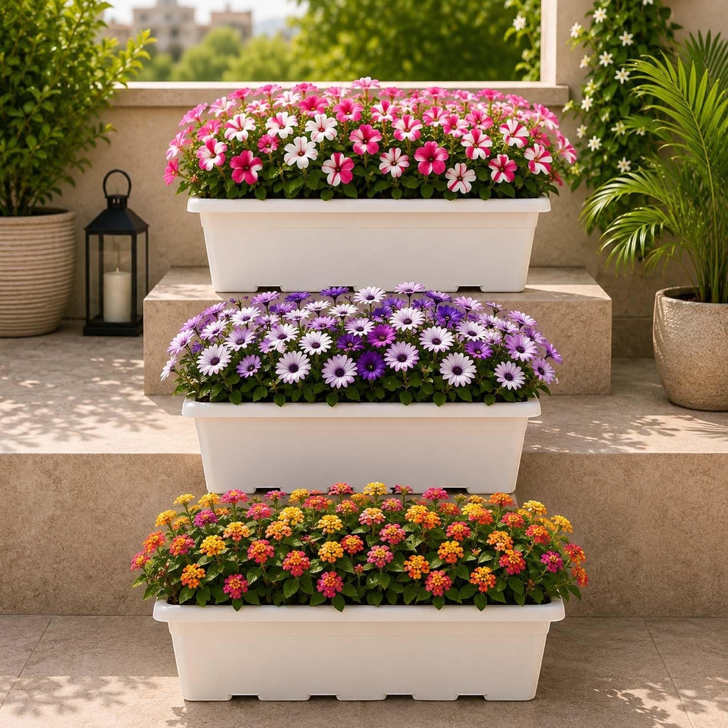 GoHooked 24-inch white plastic rectangular window planter pots filled with colorful flowers on a tiered patio.