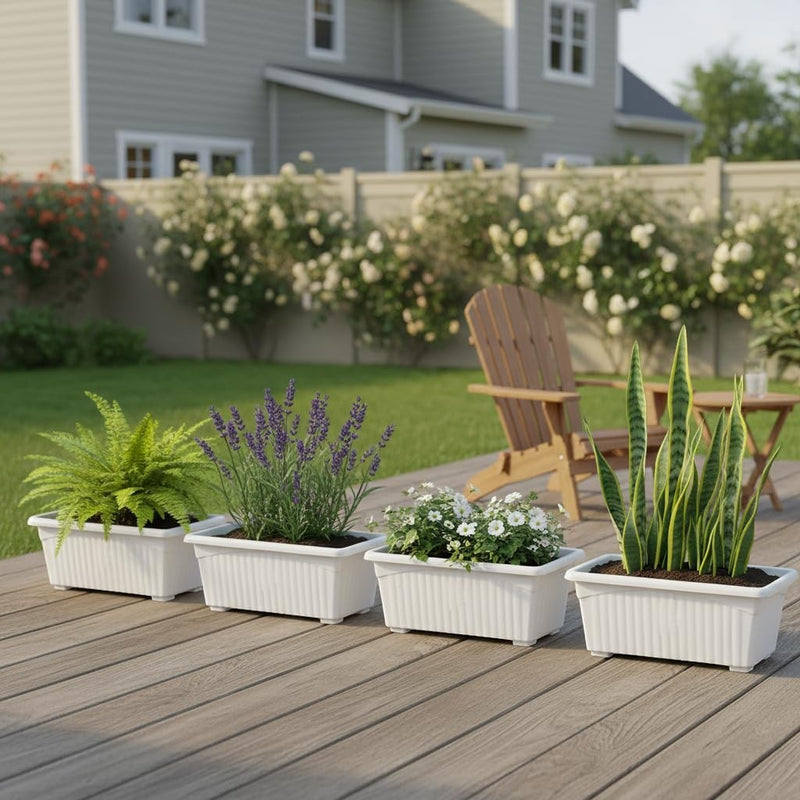Go Hooked white rectangular plastic planter pots with fluted design, set of 4, holding plants on a wooden deck.