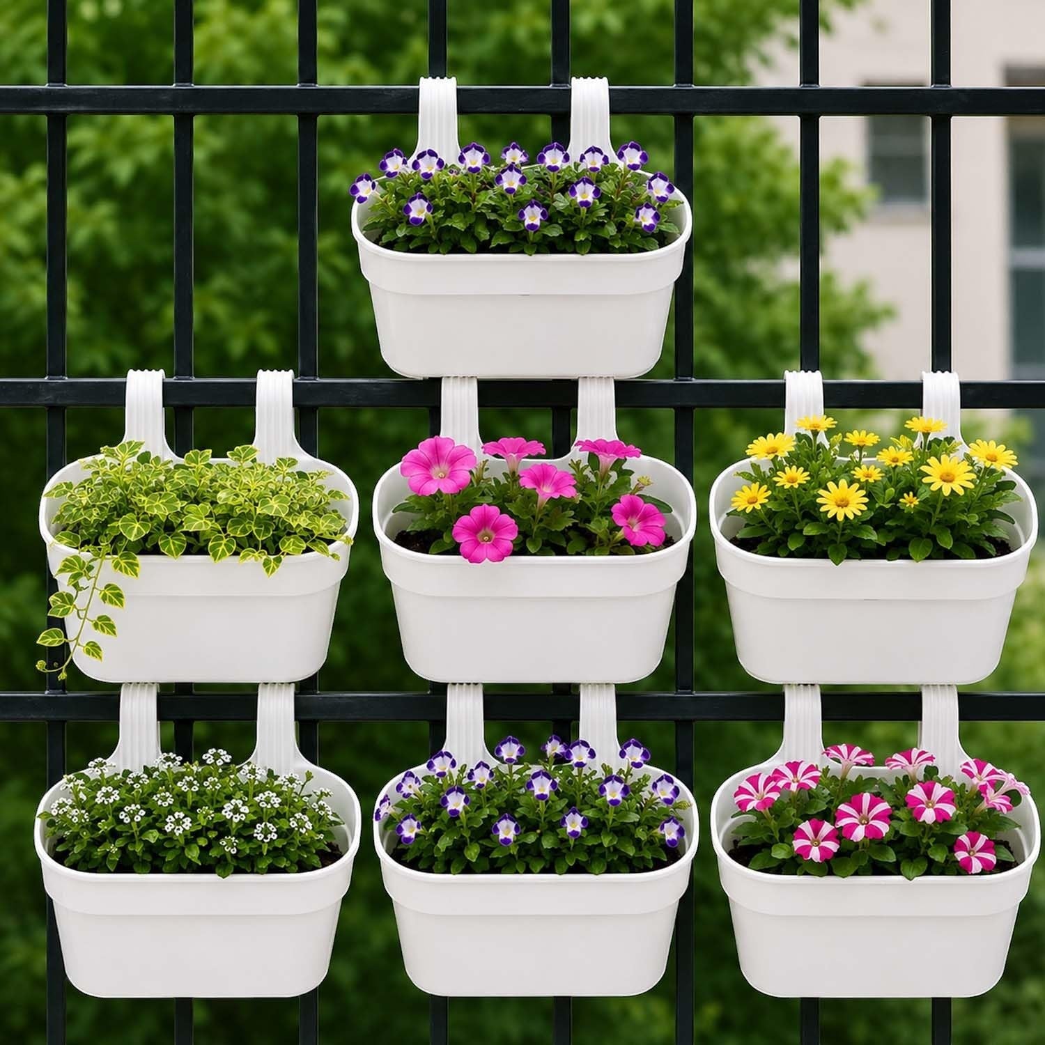 GoHooked white plastic railing hanging planters with purple, pink, and yellow flowers on a black fence.