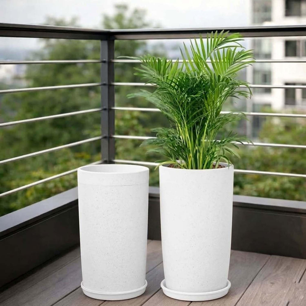 GoHooked white speckled plastic planters with saucers, one with a green palm plant, on a wooden deck.