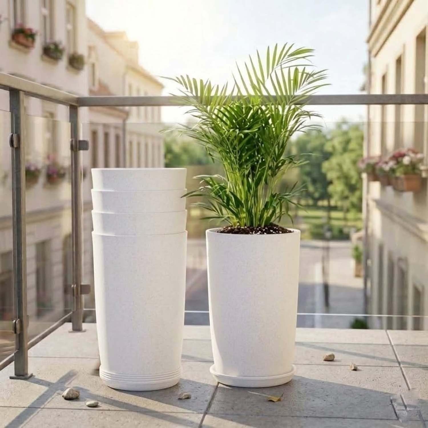 GoHooked set of 3 white speckled plastic planters, one with a palm plant, on a balcony.