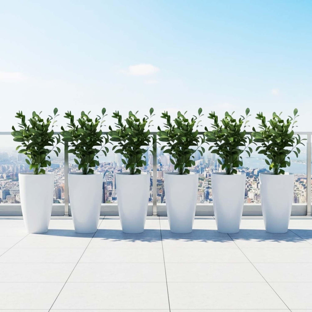 GoHooked set of 3 white plastic planters with green plants on a balcony overlooking a city skyline.