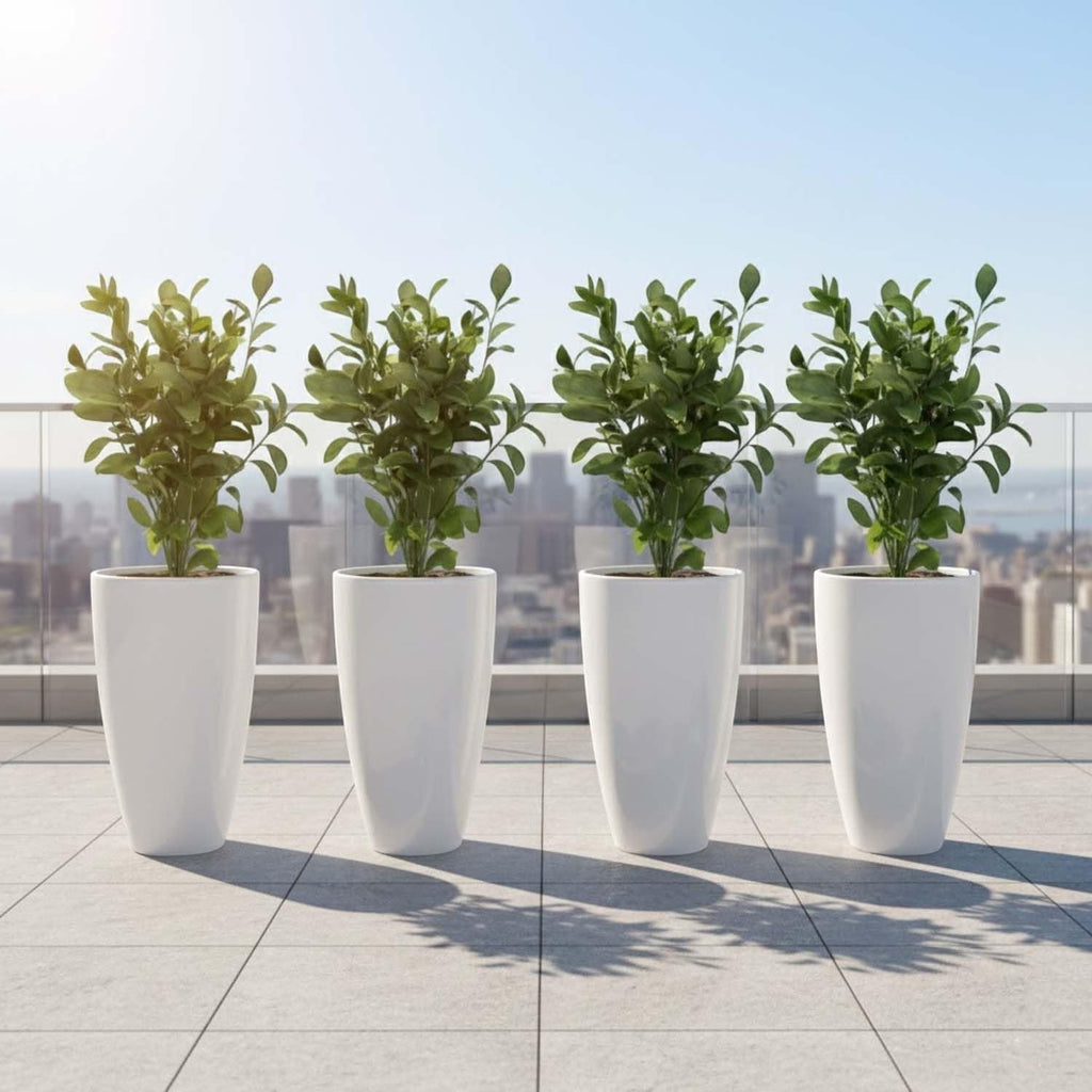 GoHooked white tapered plastic planters with green plants on a tiled balcony with city skyline.