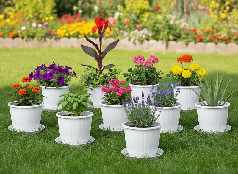 GoHooked white plastic planters with assorted flowers and plants on a green lawn.