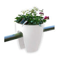 GoHooked white plastic railing planter with white and pink flowers and decorative butterflies.