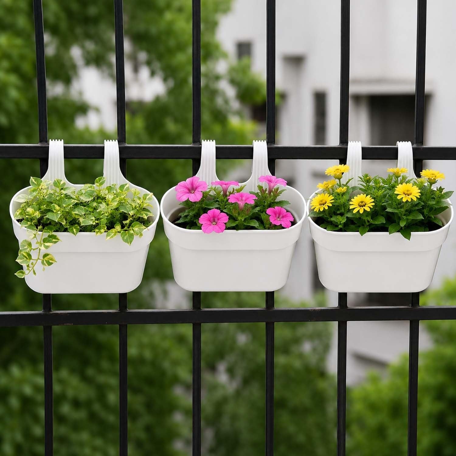 GoHooked white plastic railing planters with pink and yellow flowers, set of 3 shown on a black fence.