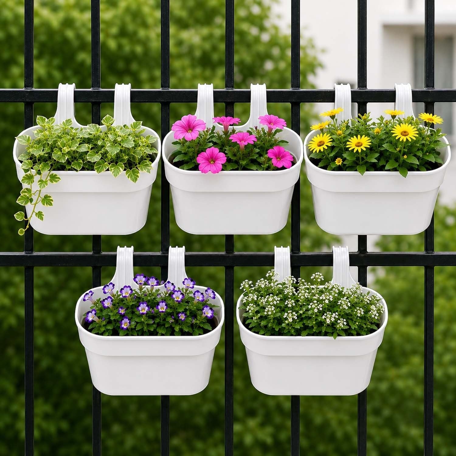 GoHooked white plastic railing hanging planters with pink, yellow, and purple flowers on a black fence.