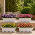 GoHooked pack of 4 white plastic rectangular window planters filled with purple, pink, yellow, and orange flowers.