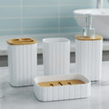 Go Hooked white plastic ribbed bathroom accessories set with bamboo lids: soap dispenser, tumbler, toothbrush holder, and soap dish.