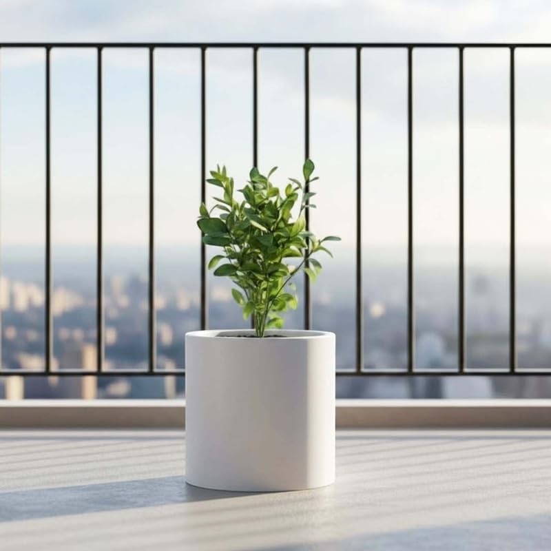 Go Hooked 10-inch white polymer round planter with a small green plant on a balcony.
