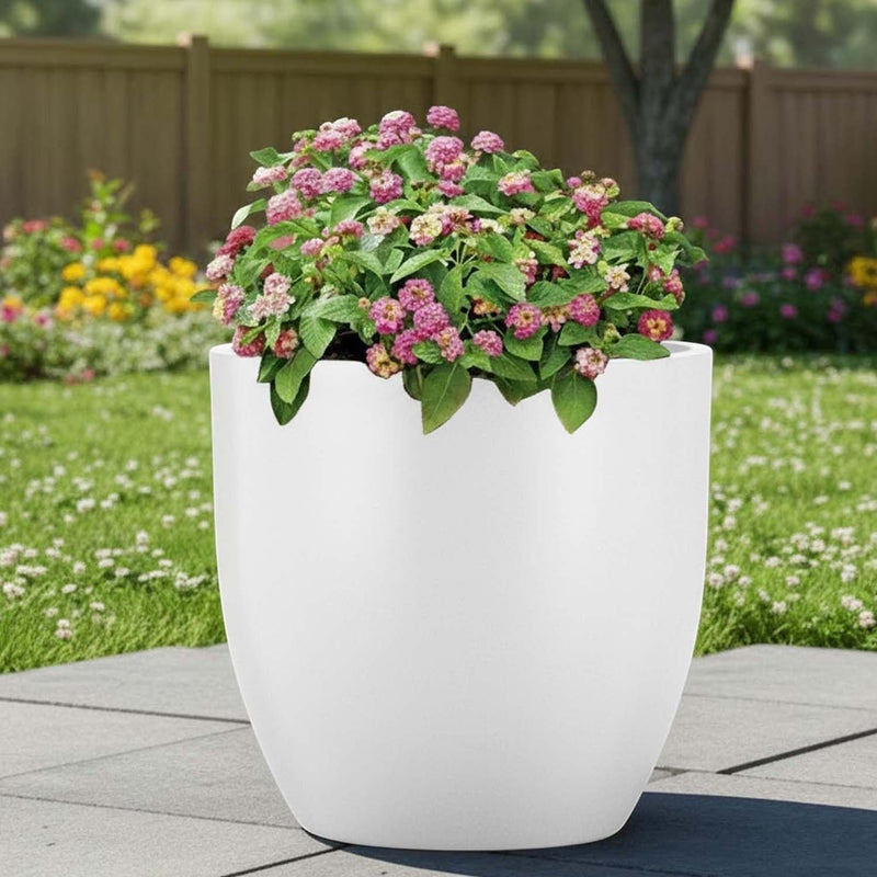 Go Hooked white polymer planter with pink flowers, modern round design, 20-inch size, suitable for indoor/outdoor use.