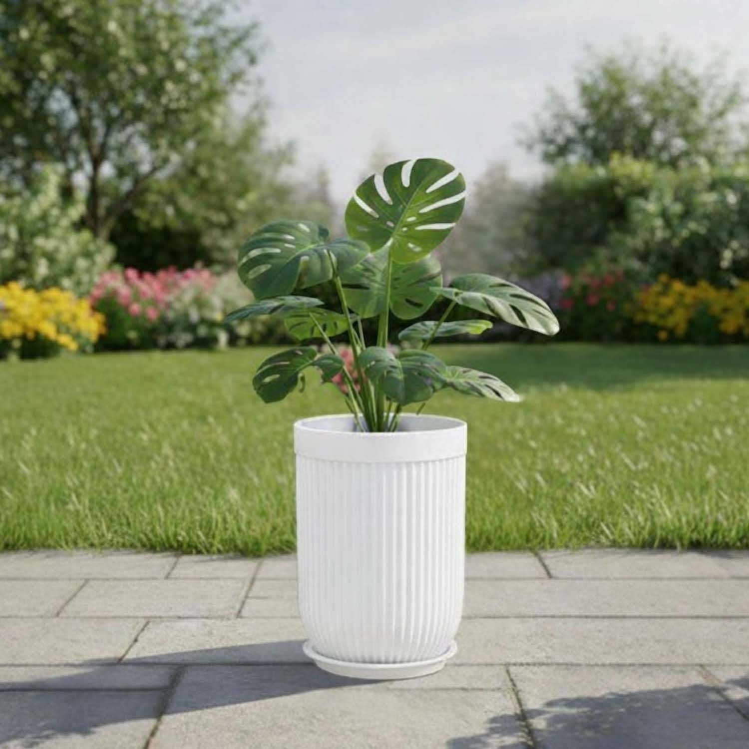 GoHooked white polymer planter with ribbed design and saucer tray, holding a large green plant outdoors.