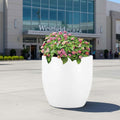 GoHooked 24-inch white polymer round planter with pink flowers, perfect for modern indoor or outdoor decor.