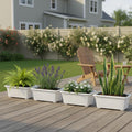 GoHooked white rectangular plastic plant pots with fluted detail, set of 4, on a wooden deck with plants.