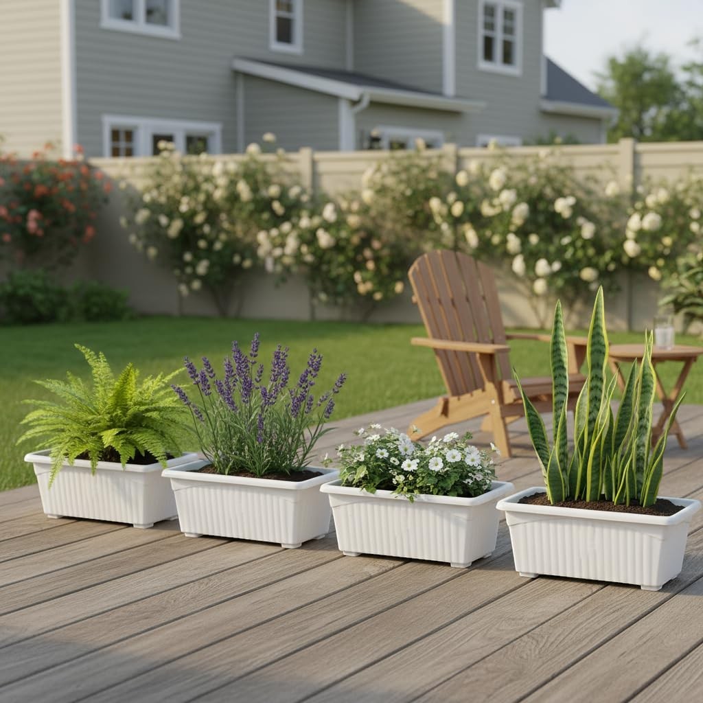 GoHooked white rectangular plastic plant pots with fluted detail, set of 4, on a wooden deck with plants.