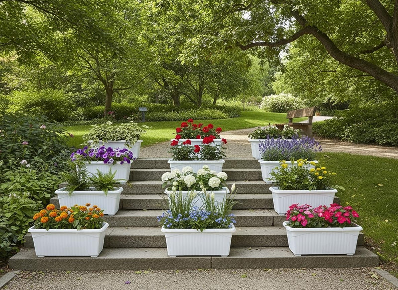 GoHooked white rectangular plastic planters filled with various flowers and greenery, arranged on garden steps.