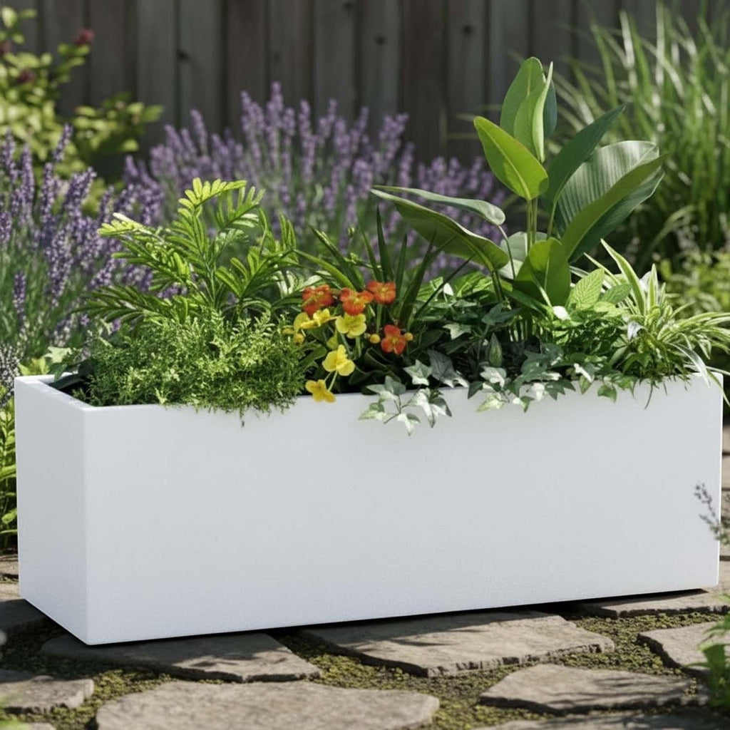 GoHooked white rectangular polymer planter filled with lush green plants and flowers in a garden setting.