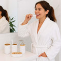 Go Hooked white ribbed plastic bathroom accessories set with soap dispenser, toothbrush holder, tumbler, and soap dish.