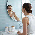 Go Hooked white ribbed plastic bathroom accessories set with soap dispenser, toothbrush holder, tumbler, and soap dish.