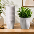 GoHooked set of 10 white marble texture plastic planter pots with a modern ribbed design on a wooden table.