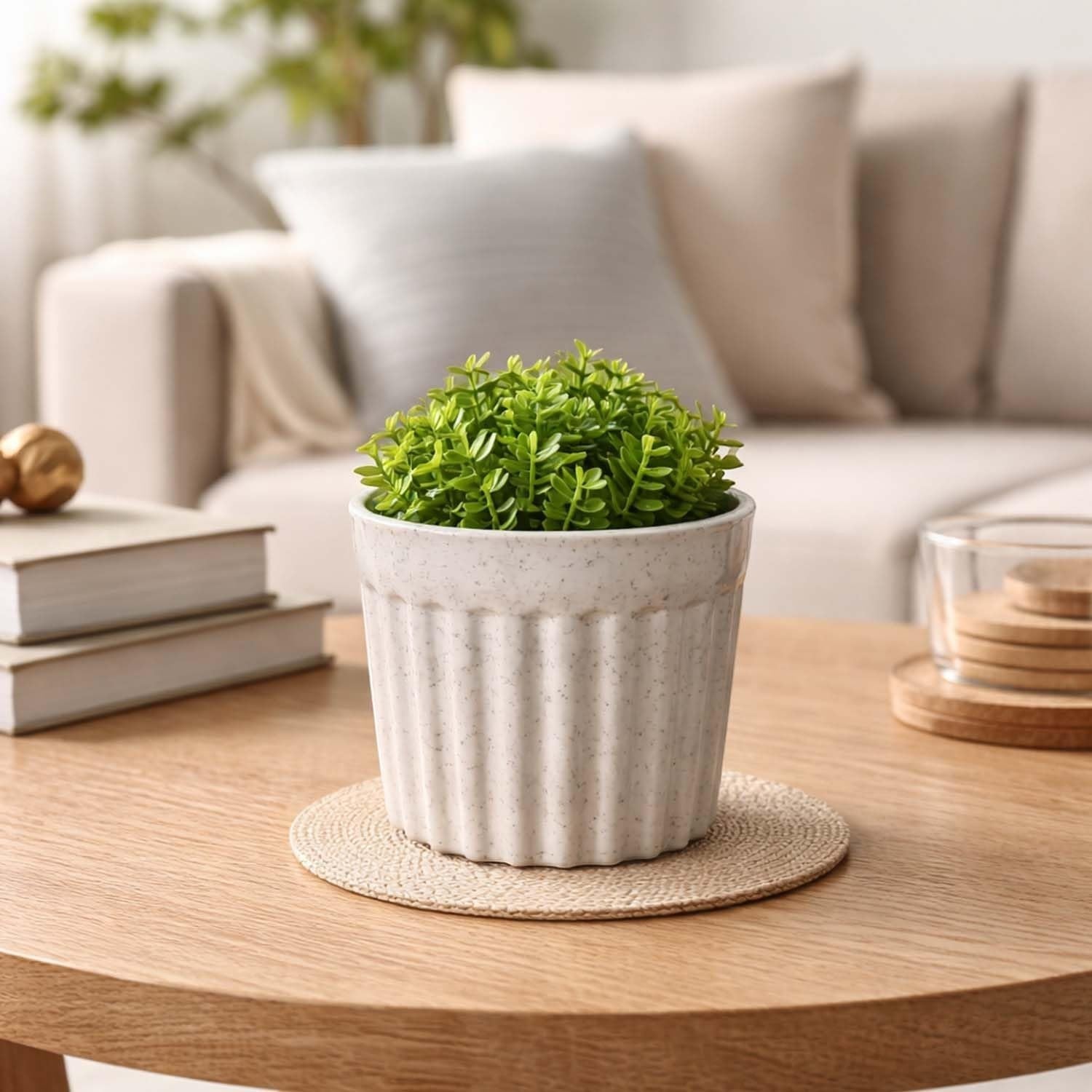 GoHooked white ribbed plastic flower pot with marble finish, holding a small green plant on a wooden table.