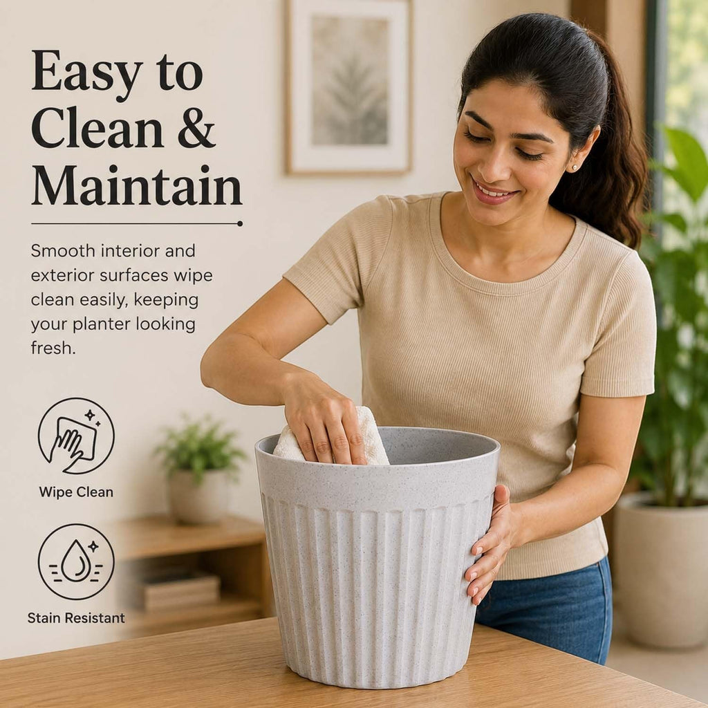 A woman cleaning a GoHooked white marble-textured plastic planter with a ribbed design on a wooden table.