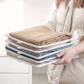 GoHooked white plastic stackable clothing organizer trays holding neatly folded shirts and sweaters