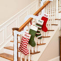 Go Hooked white tinsel garland draped on a staircase with Christmas stockings