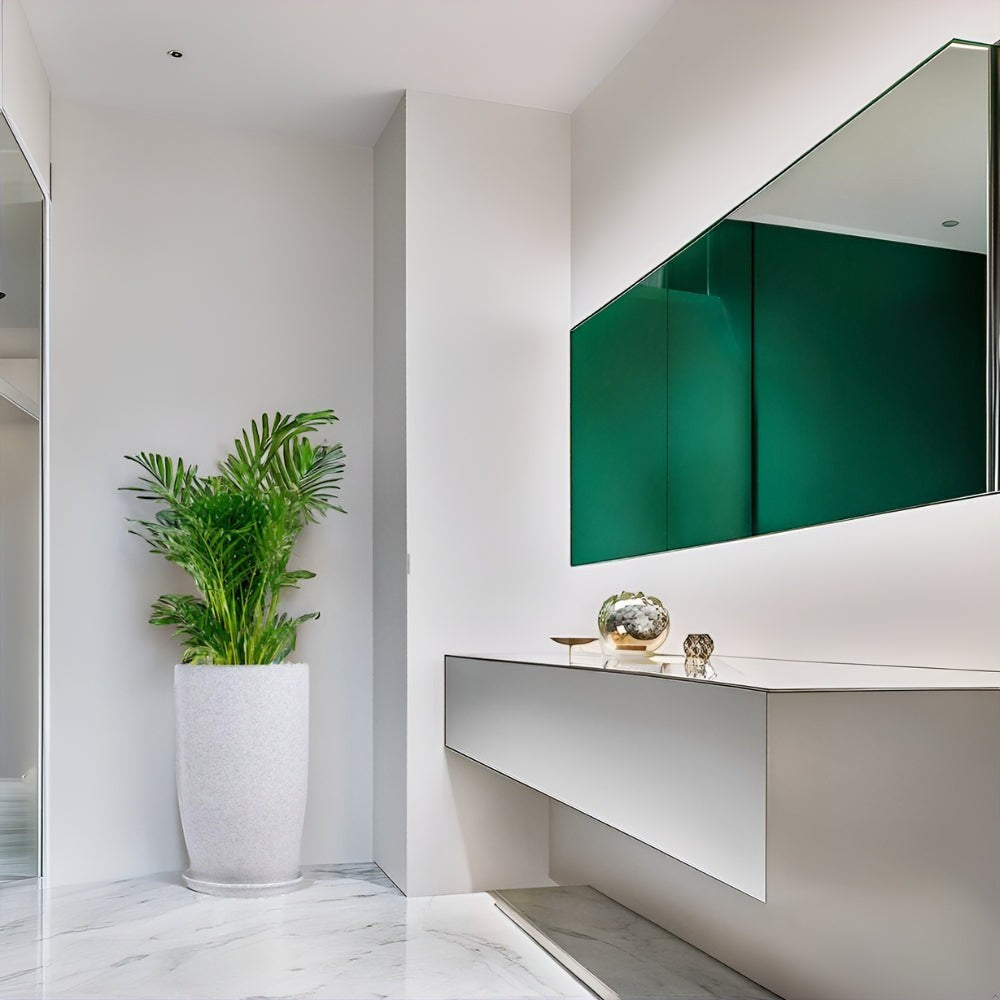 GoHooked white 18-inch tower planter with saucer tray holding a green plant in a modern minimalist home entryway