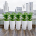 GoHooked pack of five white 18-inch tower planters with saucer trays, displayed on a balcony with green plants.