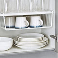 GoHooked white wire under shelf basket for cabinet storage, made of durable powder-coated iron. Holds mugs, bowls, and plates.