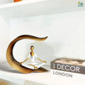 Go Hooked white polyresin meditating woman yoga statue with gold accents, seated in lotus pose.