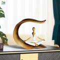 Go Hooked white polyresin meditating woman yoga statue with gold accents, seated in lotus pose.