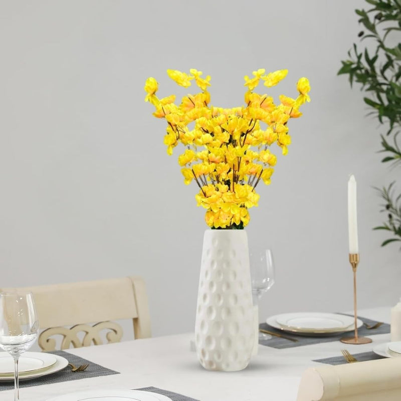 GoHooked yellow artificial flowers in a white textured ceramic vase, perfect for home or office decor.
