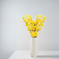 GoHooked yellow artificial flowers in a white textured vase, realistic faux blossoms for home and office decor.
