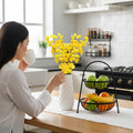 Go Hooked yellow artificial flowers in a textured white vase on a kitchen counter.