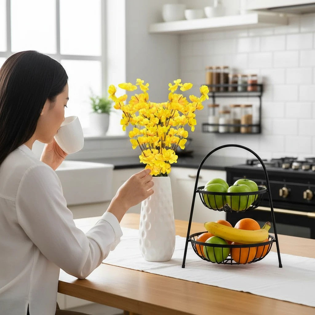 Go Hooked yellow artificial flowers in a textured white vase on a kitchen counter.