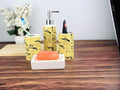 Go Hooked yellow ceramic bathroom set with gun print, includes soap dispenser, toothbrush holder, tumbler, and soap dish.