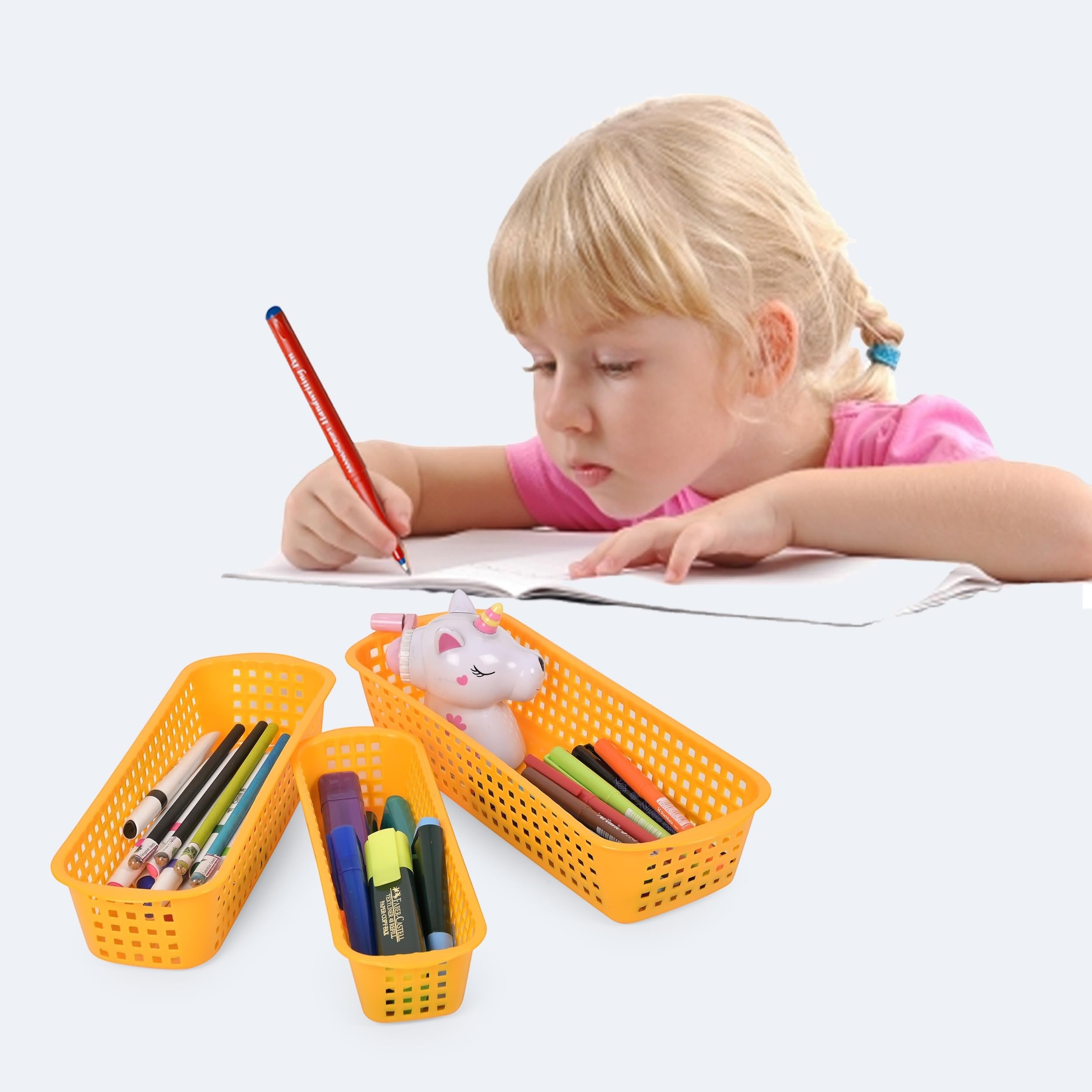 GoHooked yellow plastic drawer organizers holding pens, markers, and a unicorn toy, with a child writing in the background.