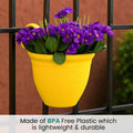 GoHooked yellow plastic planter with purple flowers hanging on a black railing. BPA-free and durable.