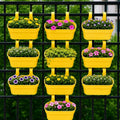 GoHooked yellow plastic railing hanging planter pots with double hooks, set of 10. Rectangular pots hold various flowers and plants.