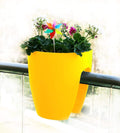 GoHooked yellow plastic railing planter, 12 inch, set of 2, with flowers and a pinwheel decoration.
