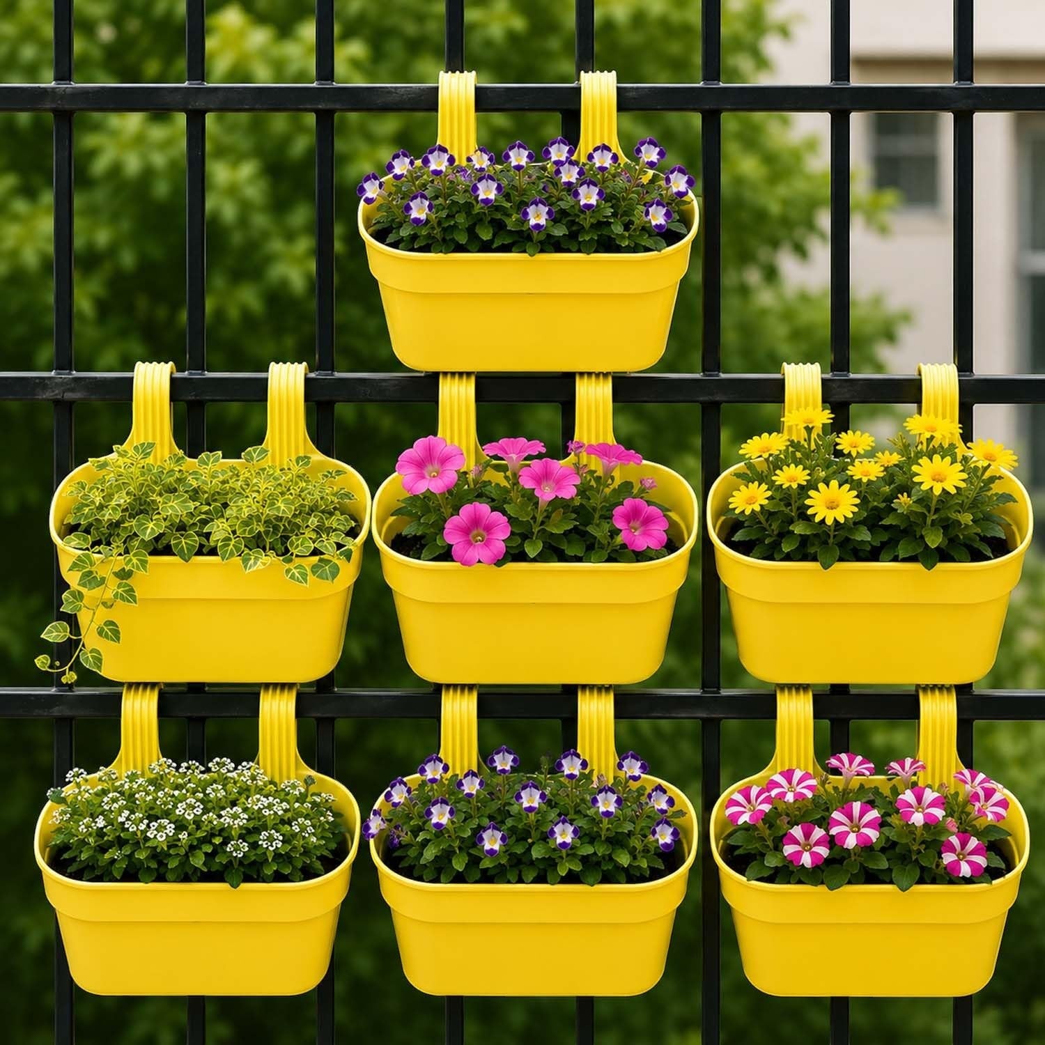 GoHooked yellow plastic railing hanging planters with assorted flowers, set of 3. Rectangular pots with double hooks for balcony or fence.