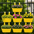 GoHooked set of 7 yellow plastic railing hanging planters with double hooks, holding various flowers and plants.