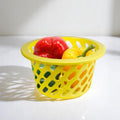 GoHooked yellow plastic mesh storage basket with red and yellow bell peppers inside.