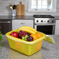 Go Hooked yellow plastic storage basket with zip net cover filled with bananas, grapes, apples, oranges, and plums.