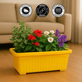 Go Hooked yellow rectangular plastic plant pot with assorted flowers and greenery. Rust resistant.