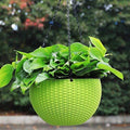 GoHookedHere green plastic hanging pot with woven texture, 7.1 inch diameter, holding lush green plants.